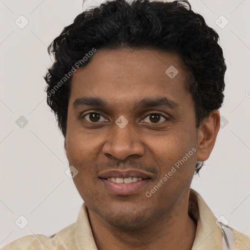 Joyful black young-adult male with short  brown hair and brown eyes