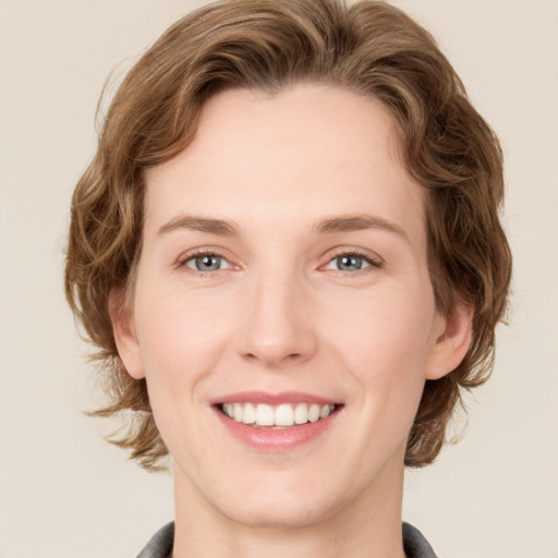 Joyful white young-adult female with medium  brown hair and green eyes