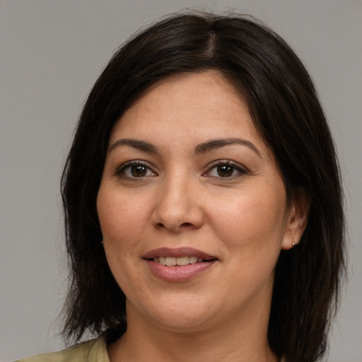 Joyful white adult female with medium  brown hair and brown eyes