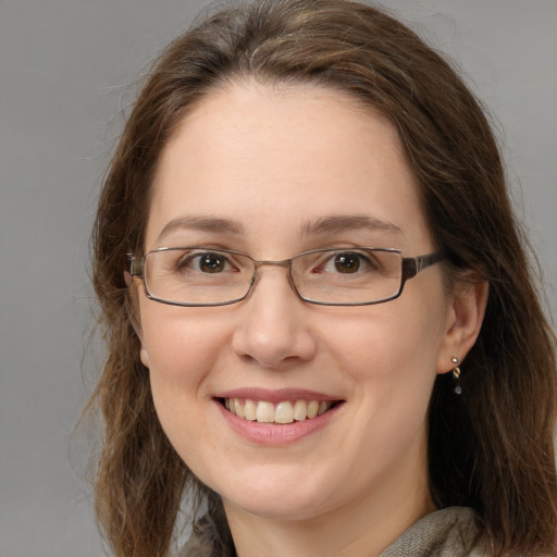 Joyful white adult female with long  brown hair and green eyes