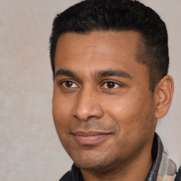 Joyful latino young-adult male with short  black hair and brown eyes