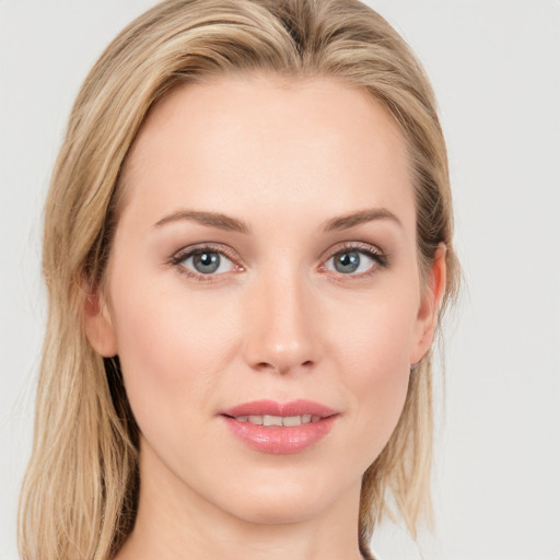 Joyful white young-adult female with long  brown hair and blue eyes