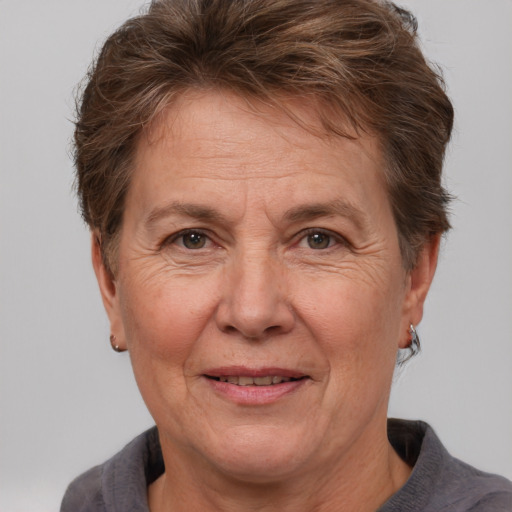 Joyful white middle-aged female with short  brown hair and brown eyes