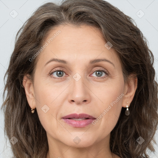 Joyful white adult female with medium  brown hair and grey eyes