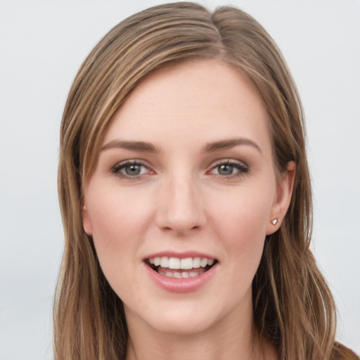 Joyful white young-adult female with long  brown hair and grey eyes