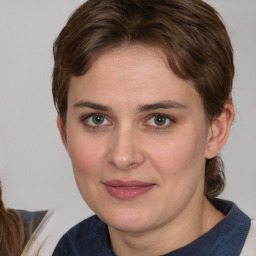 Joyful white young-adult female with medium  brown hair and blue eyes