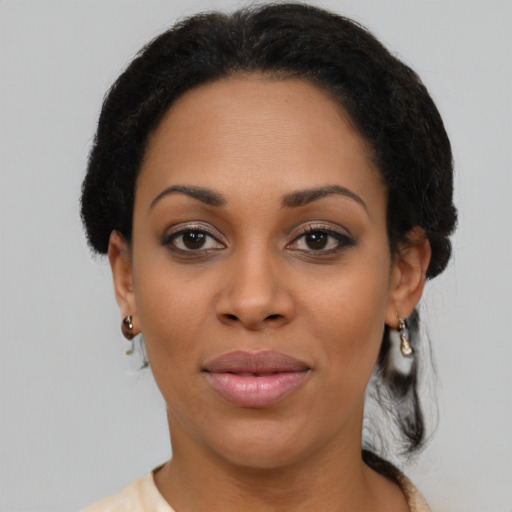 Joyful black young-adult female with medium  black hair and brown eyes