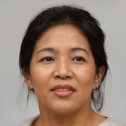 Joyful asian adult female with medium  brown hair and brown eyes