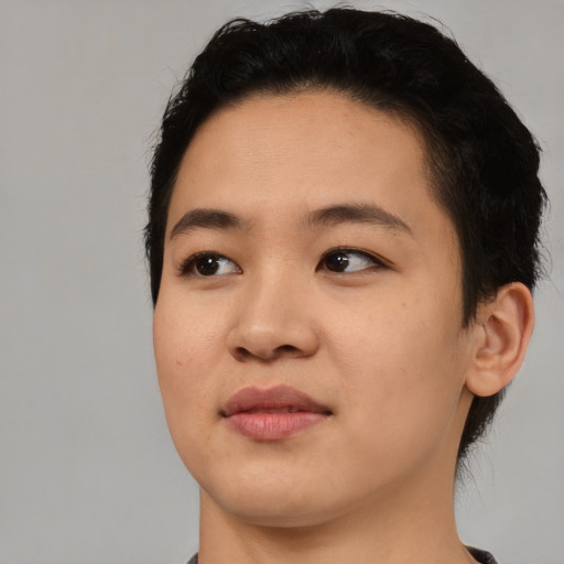Joyful asian young-adult female with short  black hair and brown eyes