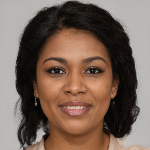 Joyful black young-adult female with medium  brown hair and brown eyes
