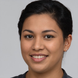 Joyful latino young-adult female with short  brown hair and brown eyes