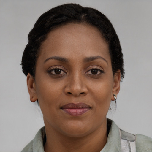 Joyful black young-adult female with short  brown hair and brown eyes