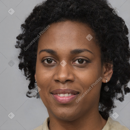 Joyful black young-adult female with long  black hair and brown eyes