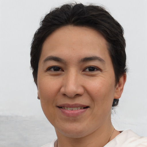 Joyful white adult female with short  brown hair and brown eyes