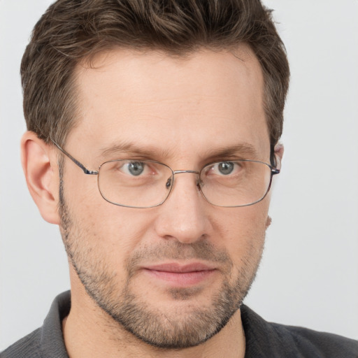 Joyful white adult male with short  brown hair and grey eyes