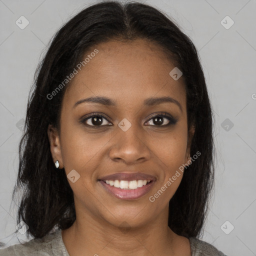 Joyful black young-adult female with long  brown hair and brown eyes