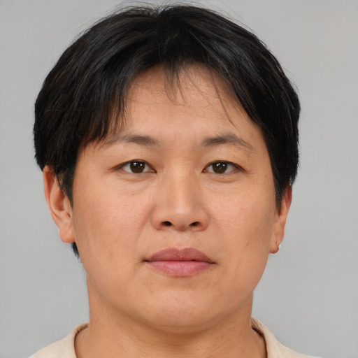 Neutral asian adult female with short  brown hair and brown eyes