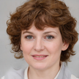 Joyful white young-adult female with medium  brown hair and blue eyes