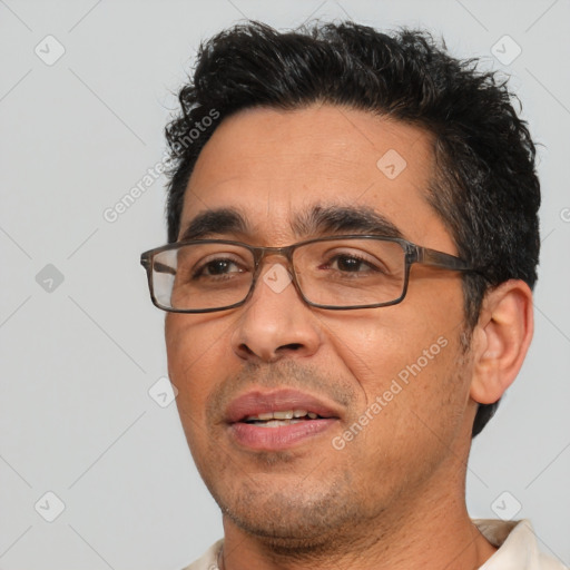 Joyful white adult male with short  black hair and brown eyes