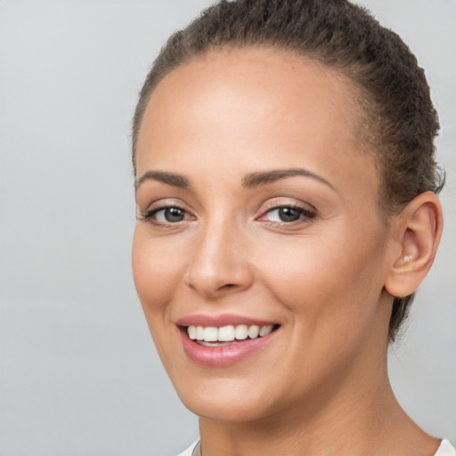 Joyful white young-adult female with short  brown hair and brown eyes