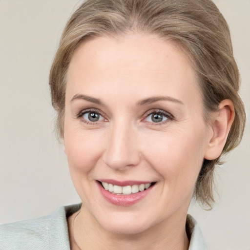 Joyful white young-adult female with medium  brown hair and blue eyes