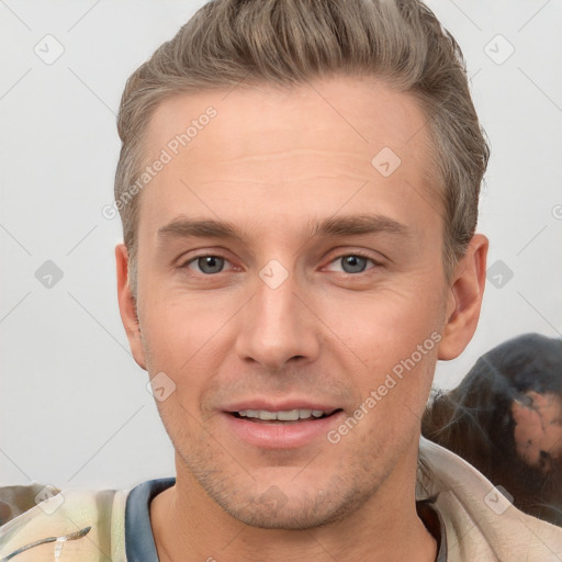 Joyful white young-adult male with short  brown hair and grey eyes