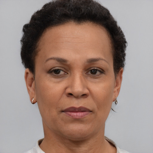 Joyful latino adult female with short  brown hair and brown eyes