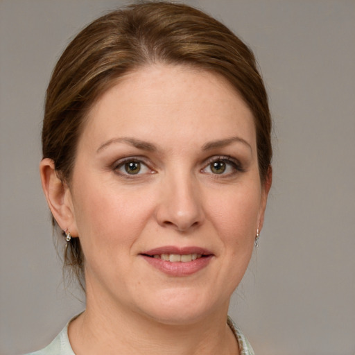 Joyful white adult female with medium  brown hair and grey eyes