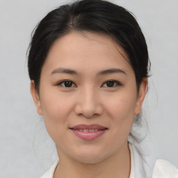 Joyful asian young-adult female with medium  brown hair and brown eyes