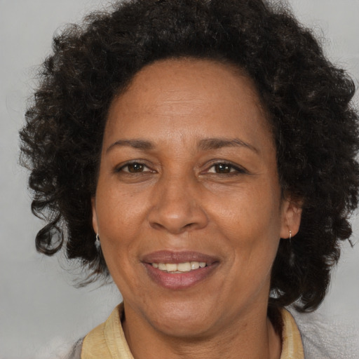 Joyful black adult female with medium  brown hair and brown eyes