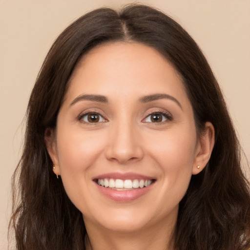 Joyful white young-adult female with long  brown hair and brown eyes