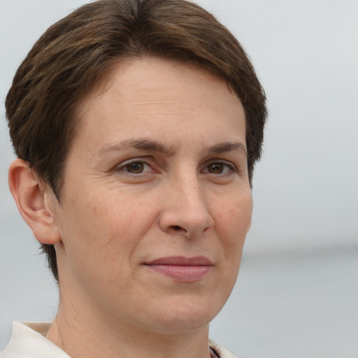 Joyful white adult female with short  brown hair and brown eyes