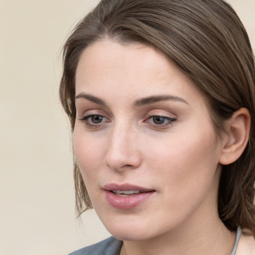 Joyful white young-adult female with medium  brown hair and grey eyes