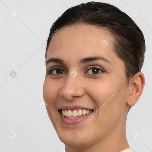 Joyful white young-adult female with short  brown hair and brown eyes