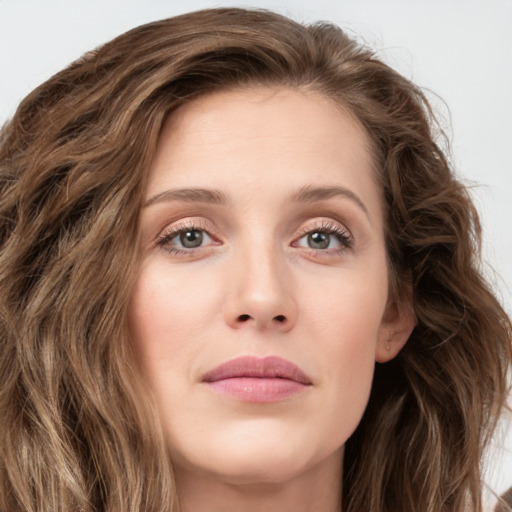 Joyful white young-adult female with long  brown hair and green eyes