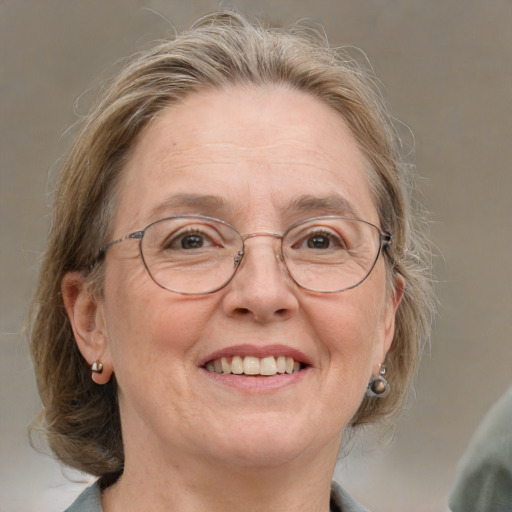 Joyful white middle-aged female with medium  brown hair and blue eyes