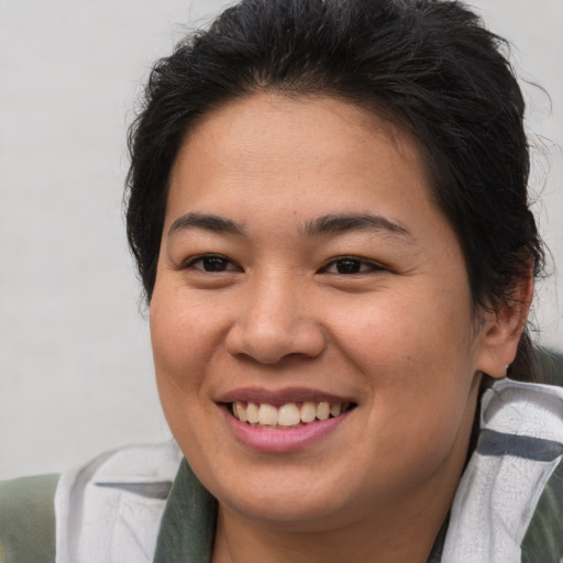 Joyful asian young-adult female with short  brown hair and brown eyes