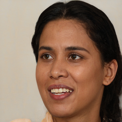 Joyful black young-adult female with medium  brown hair and brown eyes