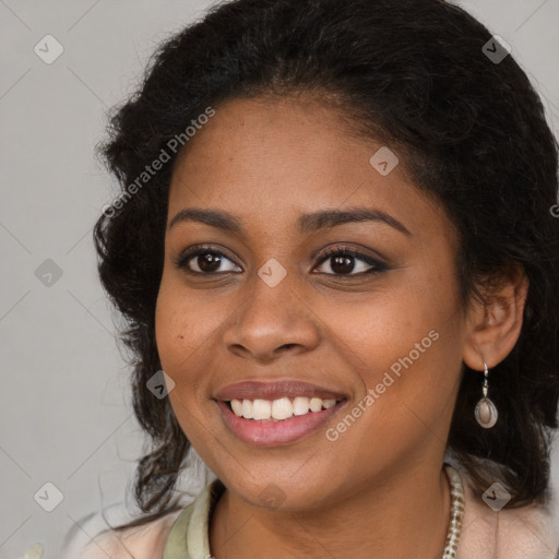 Joyful black young-adult female with long  brown hair and brown eyes