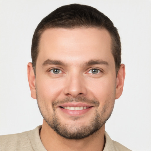 Joyful white young-adult male with short  brown hair and brown eyes