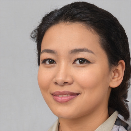 Joyful asian young-adult female with medium  brown hair and brown eyes