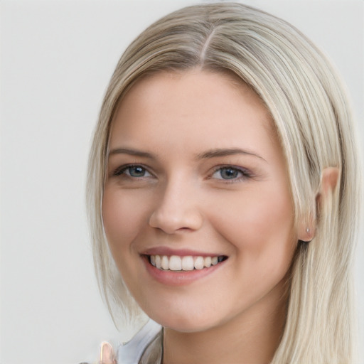 Joyful white young-adult female with long  brown hair and blue eyes