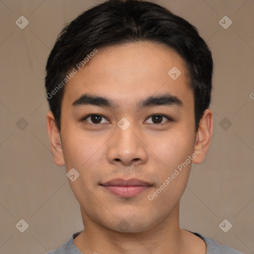 Joyful asian young-adult male with short  black hair and brown eyes