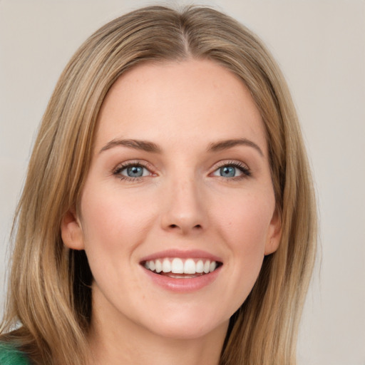 Joyful white young-adult female with long  brown hair and green eyes