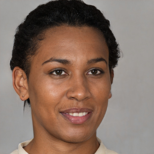 Joyful black young-adult female with short  brown hair and brown eyes