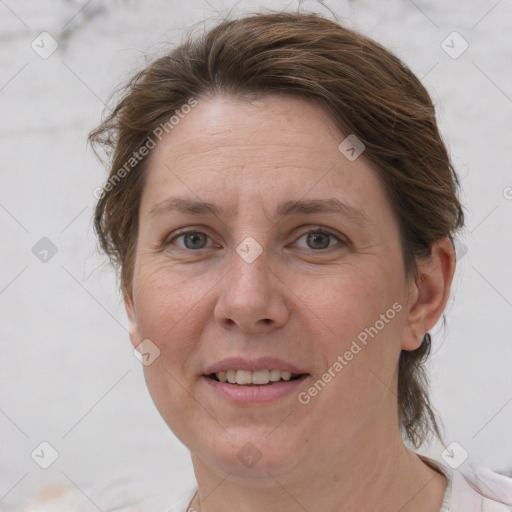 Joyful white adult female with short  brown hair and grey eyes