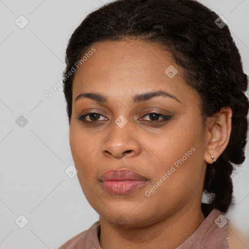 Joyful black young-adult female with long  brown hair and brown eyes