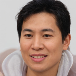 Joyful asian young-adult male with short  brown hair and brown eyes