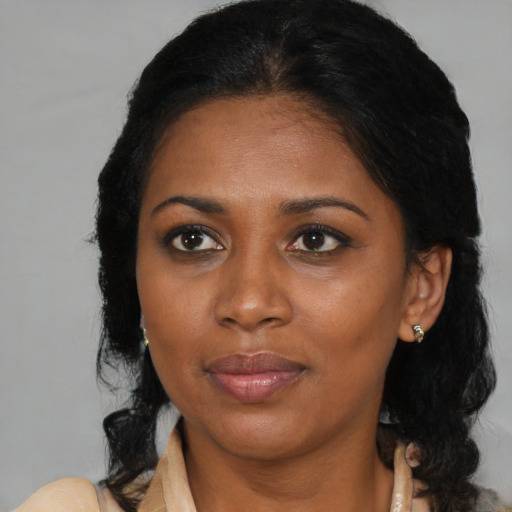 Joyful black young-adult female with medium  brown hair and brown eyes