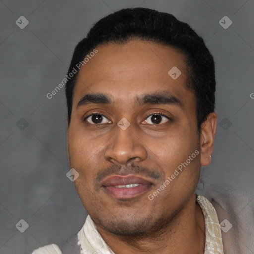 Joyful latino young-adult male with short  black hair and brown eyes